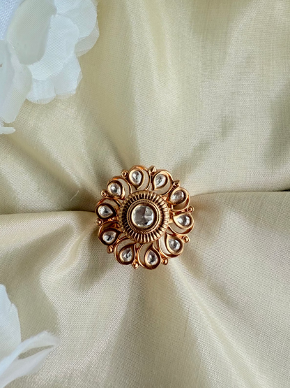 Decorative brooch on a beige fabric background with white flowers